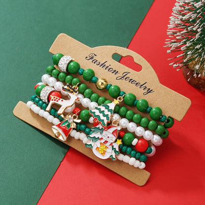 Christmas bracelet set with reindeer bells, Christmas tree beads, and woven polymer clay.